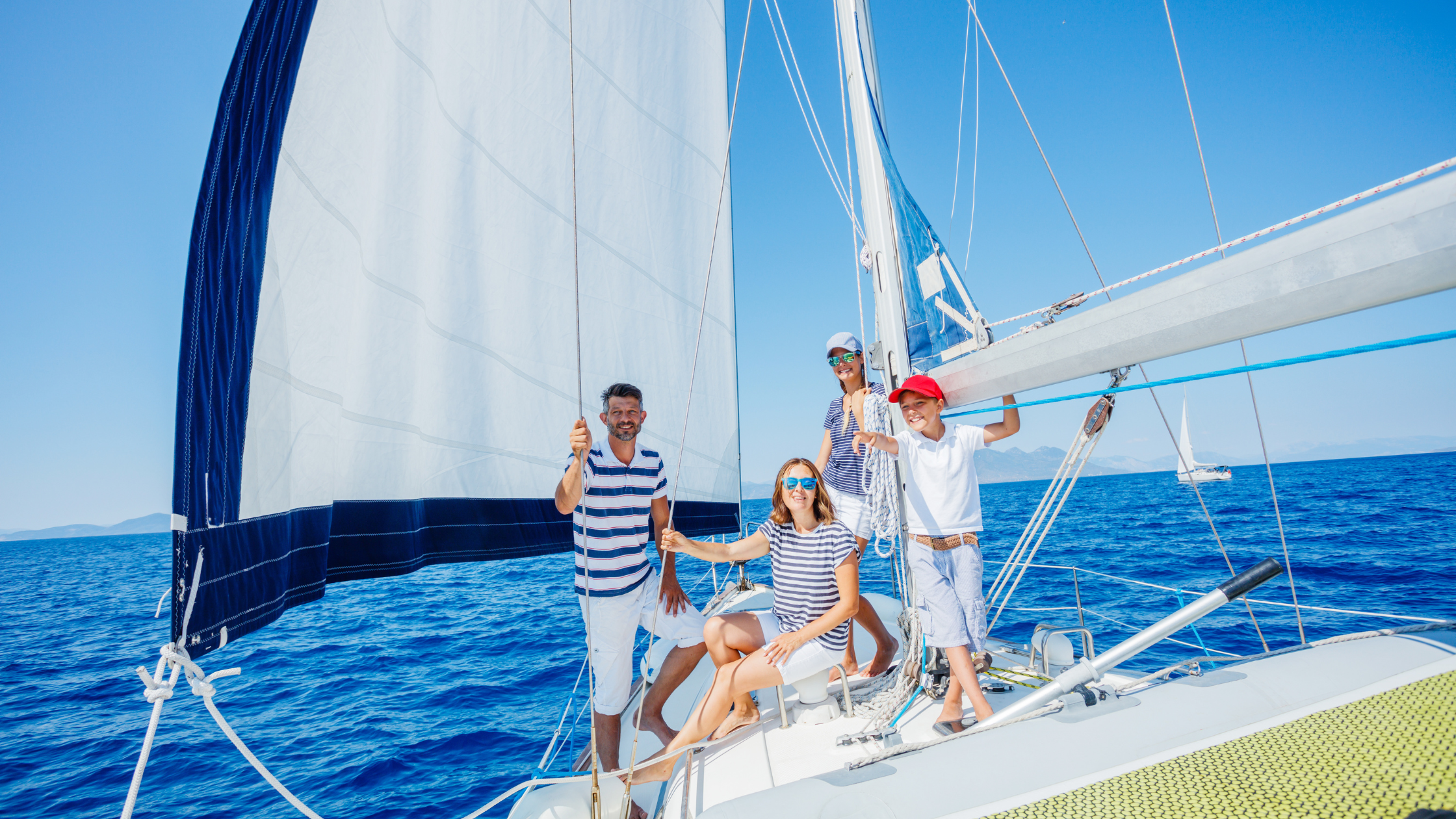 Family boating on a sailboat | Credit Max Topchii on Shutterstock